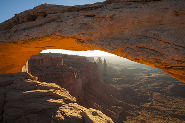 Sunrise on Mesa Arch in Utah's Canyonlands National Park. Stock.  Usage Rights: Worldwide, Social Media. - These images are protected by copyright. Delta has acquired permission from the copyright owner to the use the images for specified purposes and in some cases for a limited time. If you have been authorized by Delta to do so, you may use these images to promote Delta, but only as part of Delta-approved marketing and advertising. Further distribution (including proving these images to third parties), reproduction, display, or other use is strictly prohibited.